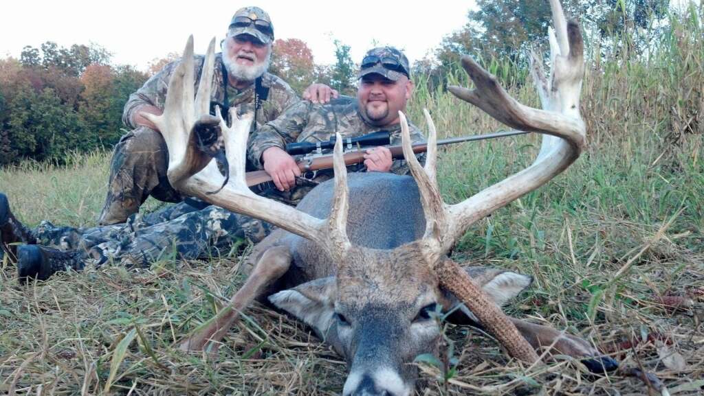 A man with deer and Gun